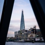 The Shard framed between dark architectural shadows, used as an example of leading lines in London architecture photography