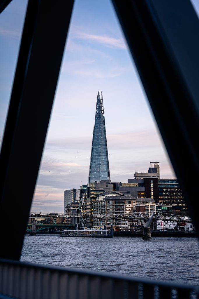 The Shard framed between dark architectural shadows, used as an example of leading lines in London architecture photography
