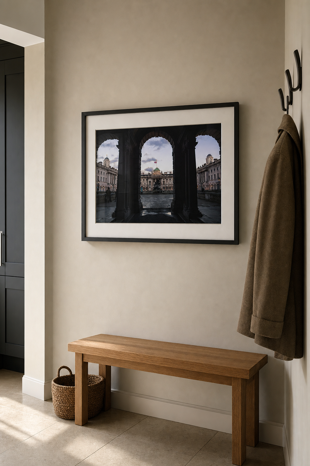 A framed London architecture photography print above a bench in a calm modern entryway.