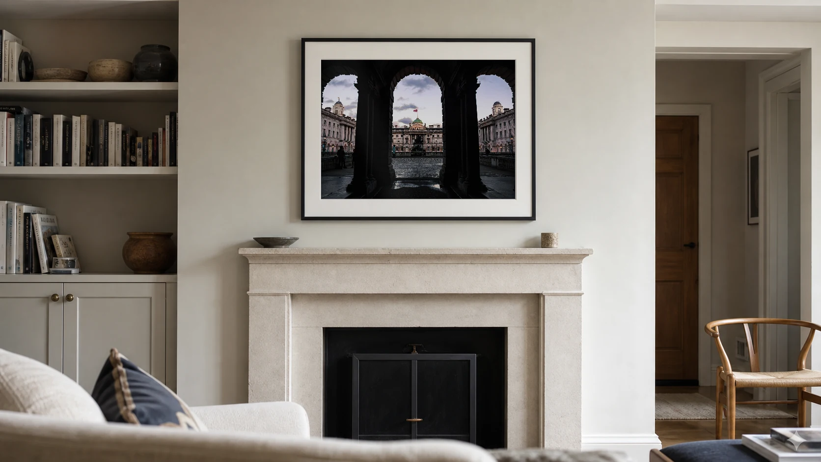 London Arches at Dusk photography print centred above a stone fireplace at seated viewing height