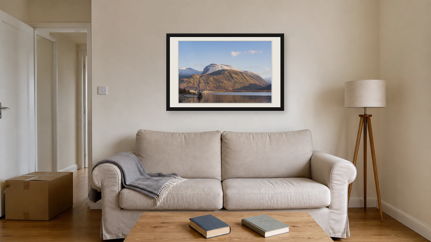 Ben Nevis and the Old Boat of Caol photography print centred above a sofa in a first home with empty wall space around it