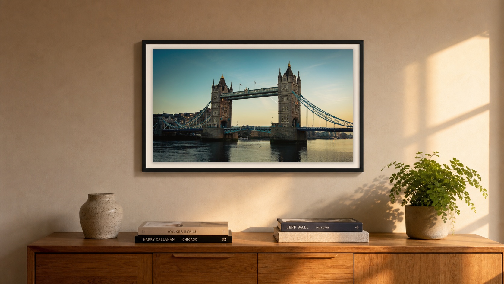 A framed Tower Bridge at Golden Hour photography print above an oak sideboard in a warm, lived-in London interior.