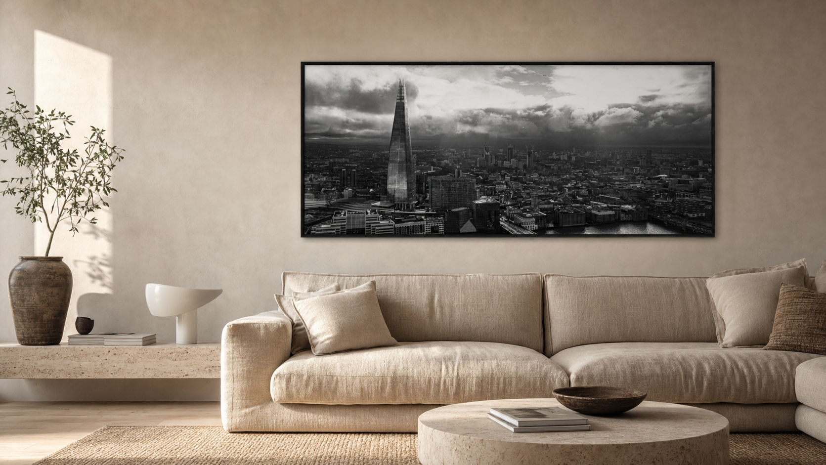 A wide black and white London panoramic photography print above a neutral sofa in a calm modern living room